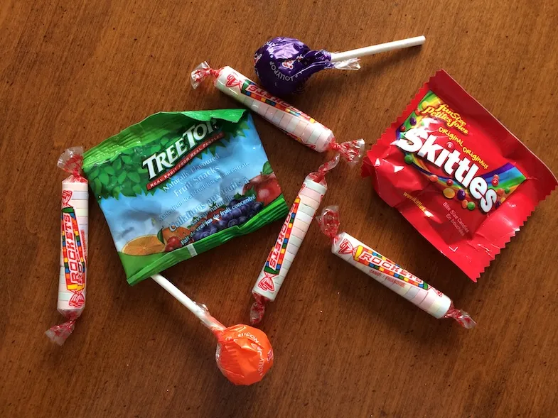 image of gluten-free candy such as skittles, rockets, fruit chews and lollipops