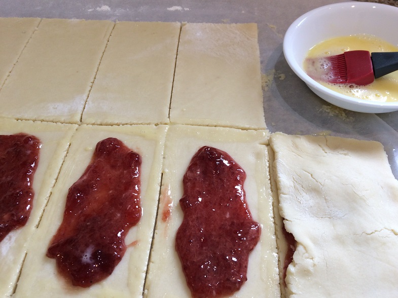 brushing eggwash to close gf poptart pastry