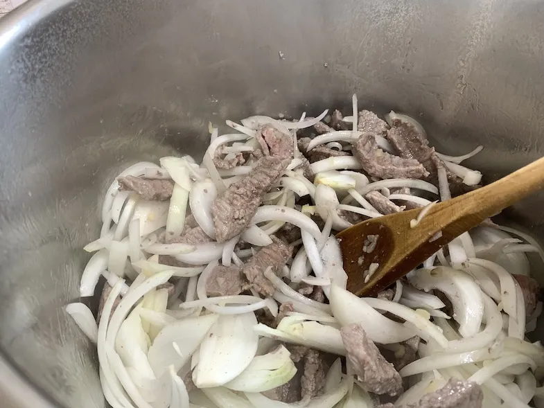 beef, onions, and garlic in the instant pot