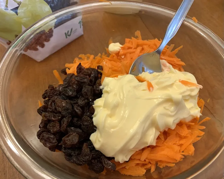 Carrot and Raisin Salad ingredients in a bowl