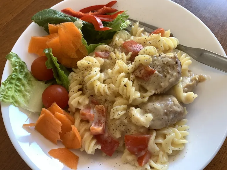 photo of salad and gluten free meatballs and rotini in a creamy sauce