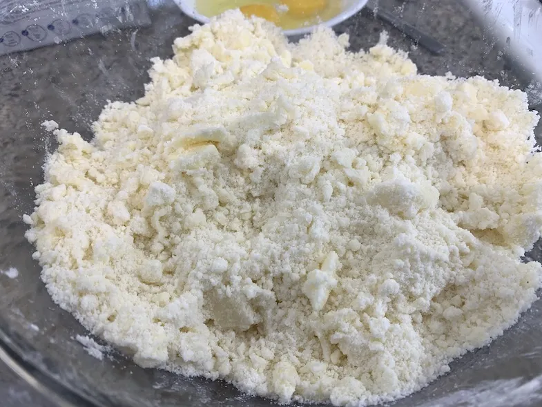 Duinkerken gluten free pie crust mix with butter in a bowl at the crumb stage