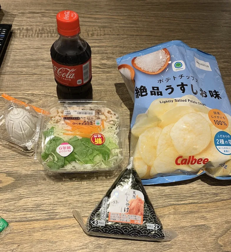 Family Mart haul of coke, chips, salad, onigiri and egg