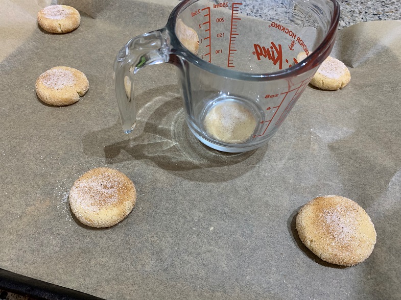 flattening cookies with a cup