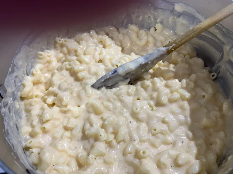 gluten-free pasta in a pot mixed with the cheese sauce