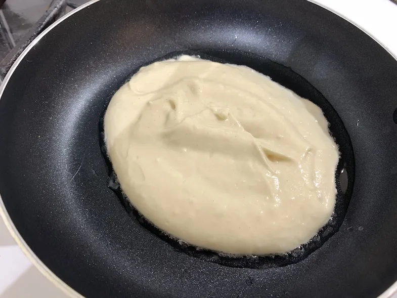 gluten-free pancake batter in a frying pan