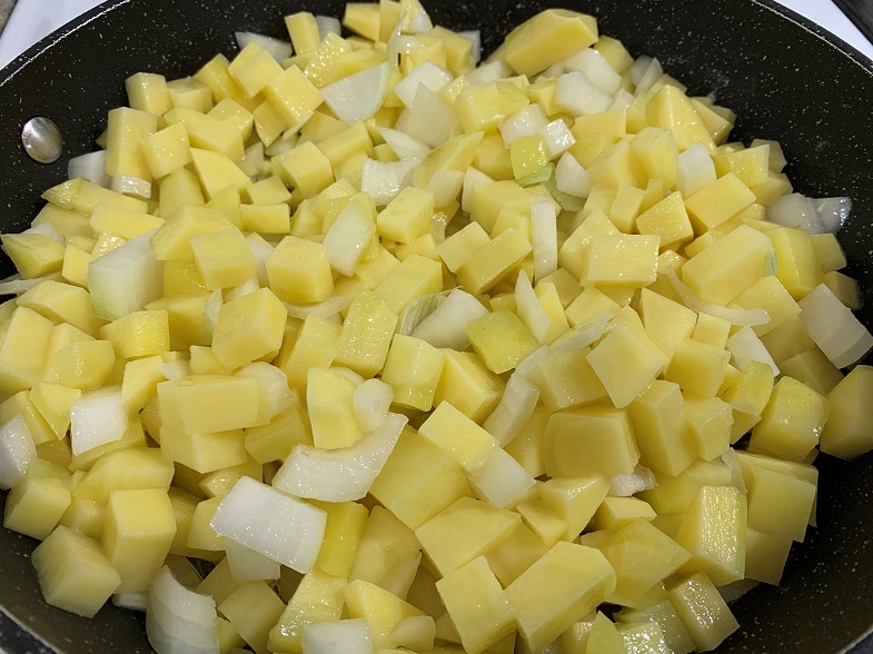 potatoes and onions in frying pan