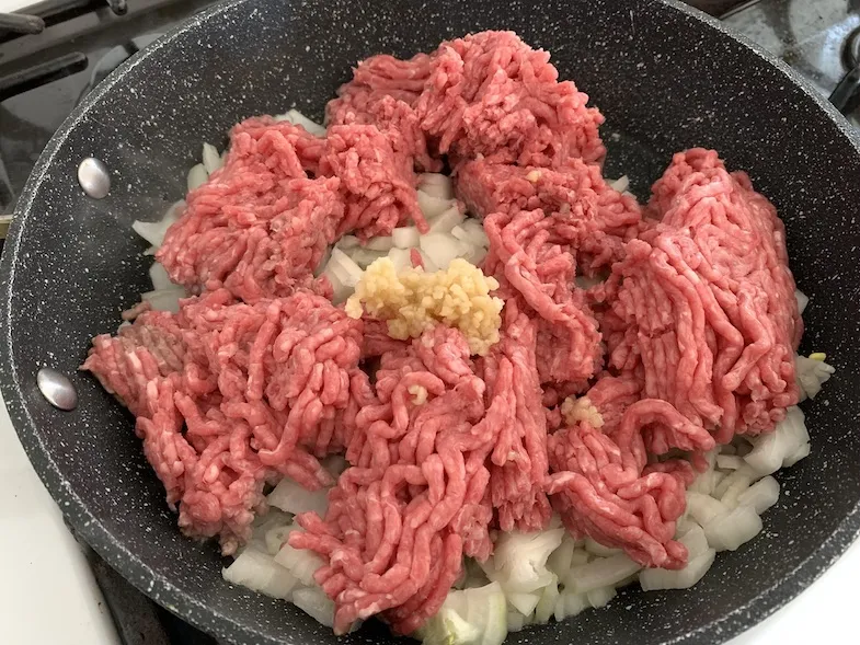 raw meat in frying pan