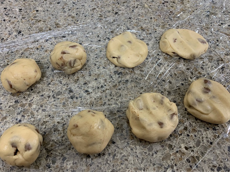 raw cookies on saran wrap