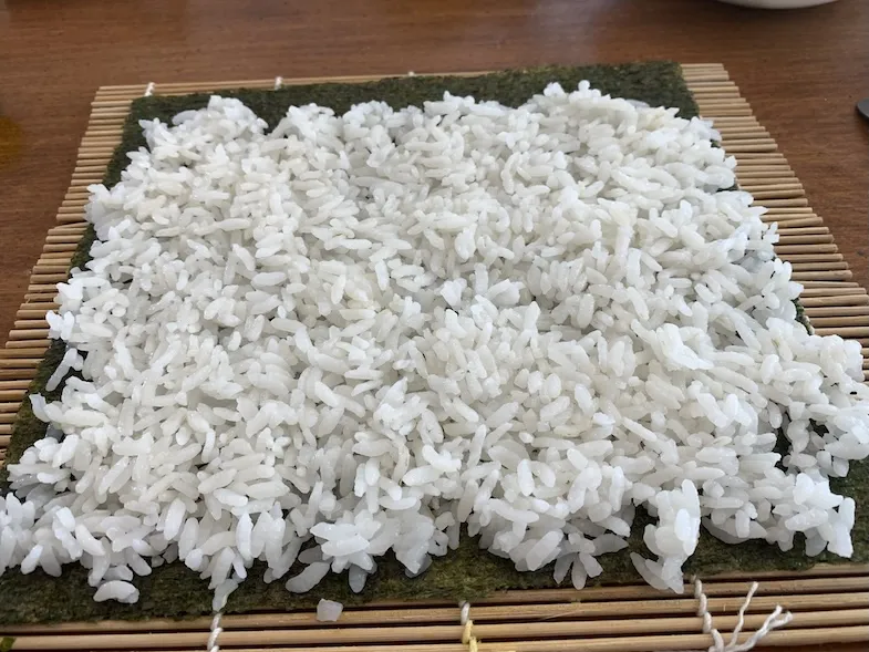 Putting sushi rice on the nori sheet