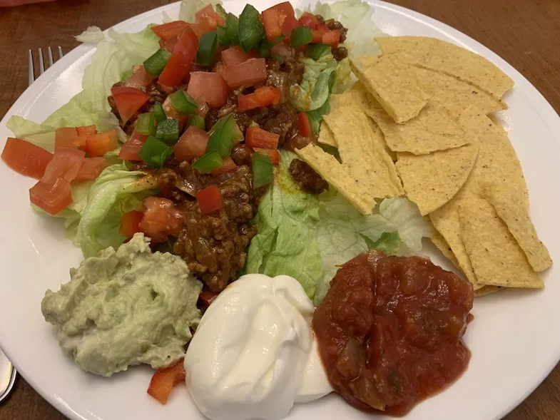 taco salad on a plate with sides