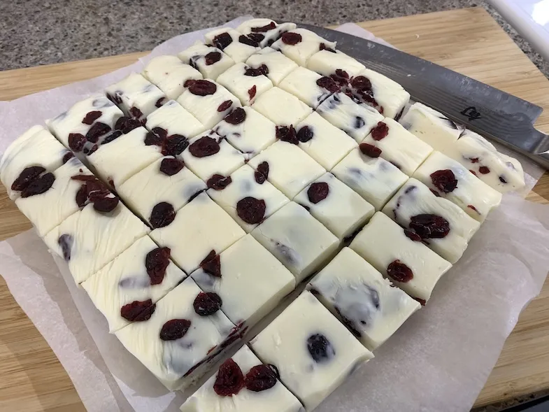 white chocolate and cranberry fudge cut up on a plate